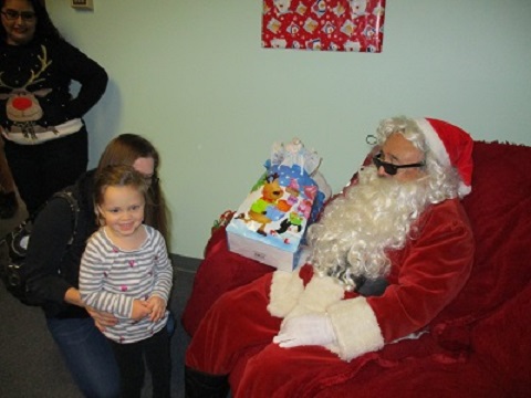 Santa posing with a Mother and Daughter